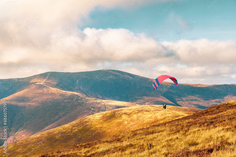 Paragliding active sport against giant mountains in highland Paragliding active sport against giant mountains in highland