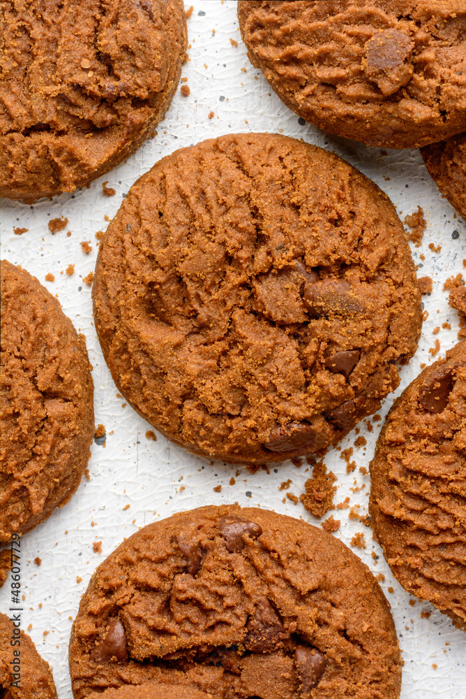 Fototapeta premium chocolate biscuits on a white surface, closeup view of round shape homemade snack taken from above