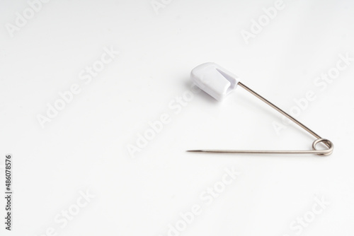 white clothespin over white background