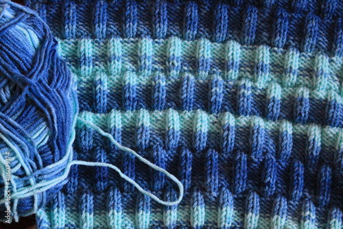 Obraz na plátně The canvas is knitted from melange yarn with knitting needles