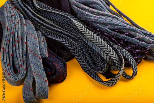 Colorful fabric accessories or pieces standing on a yellow background. accessories and rubber threads used in textile production
