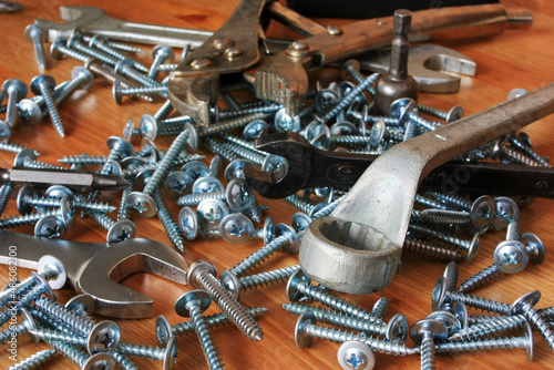 Metal screws, screwdriver bits and spanners