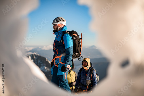 side view of man wearing ski equipment against the backdrop of blue sky and landscape