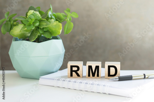 RMD required minimum distributions. text on wood cubes. text in black letters on wood blocks photo