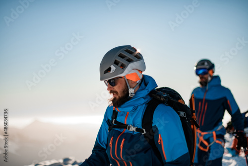 view of a man with ski helmet on his head against a blue sky background © fesenko