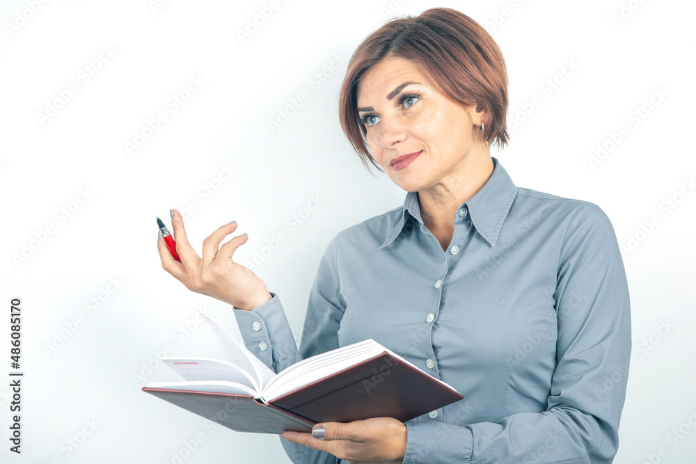 Beautiful young business girl with a red pen and notebook in hands on a white background Beautiful young business girl with a red pen and notebook in hands on a white background