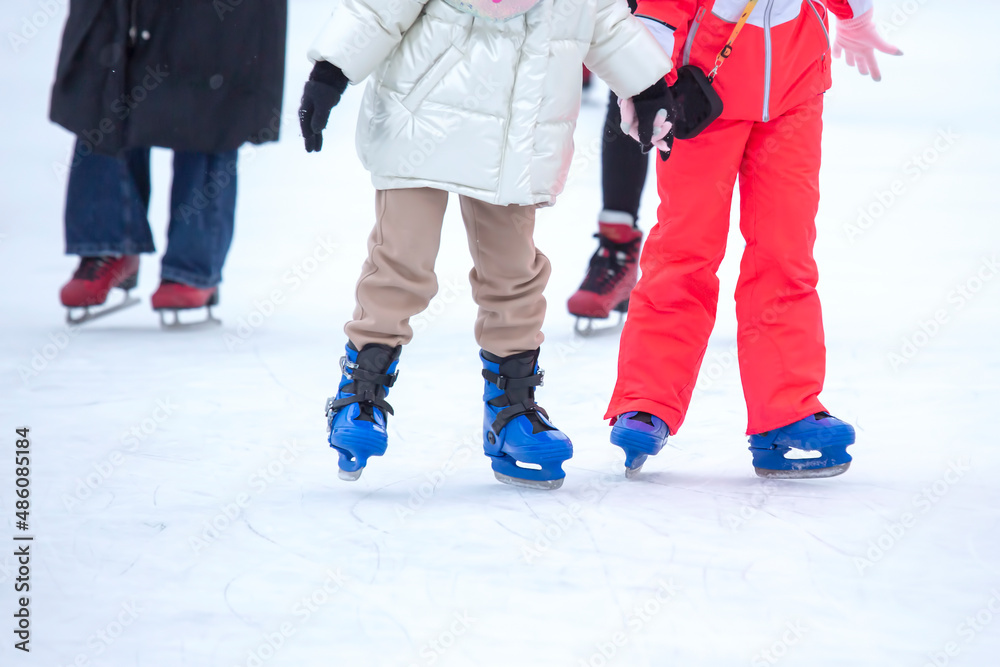 feet on skates on an ice rink. winter sport and recreation feet on skates on an ice rink. winter sport and recreation
