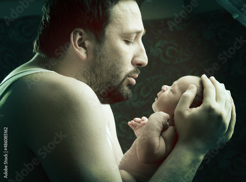 Newborn baby in father's hands , in arms