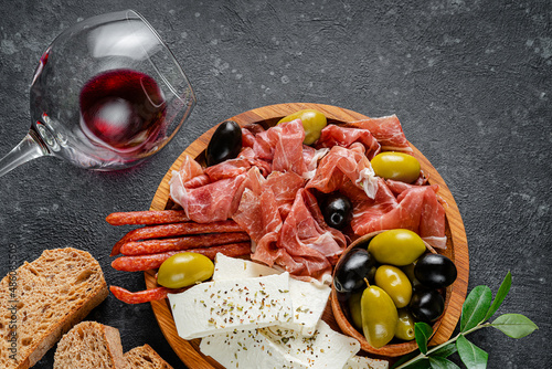 Antipasto set platter with sliced meat, cheese and olives. Top view, flat lay.