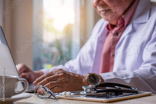 doctor working on laptop computer photo