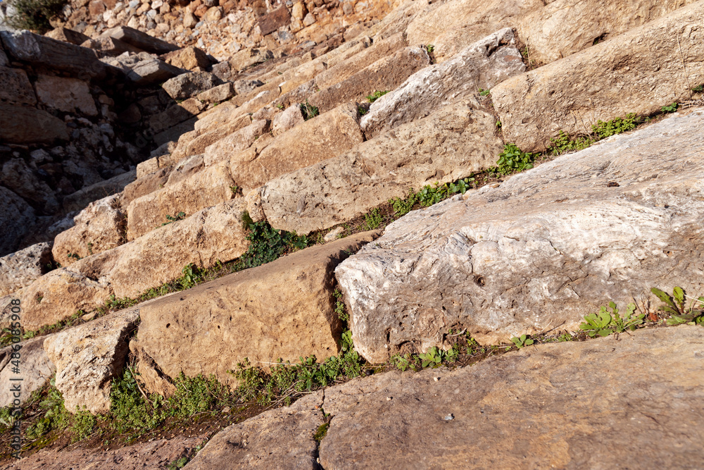 Ancient city of Syedra, Turkey. Slanted low angle view of ruined historic stone stairs. Selective focus.