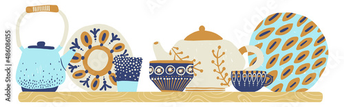 Dishware on wooden shelf. Decorative kitchen utensils and crockery