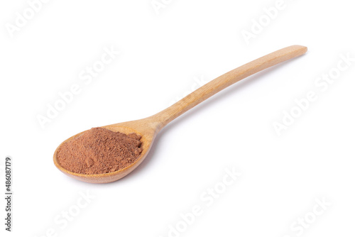 Cocoa powder in wooden spoon isolated on white background. 