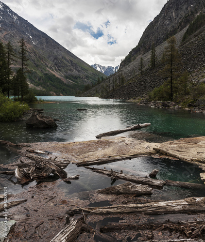 Fototapeta Naklejka Na Ścianę i Meble -  rain on a mountain lake with clear greenish water