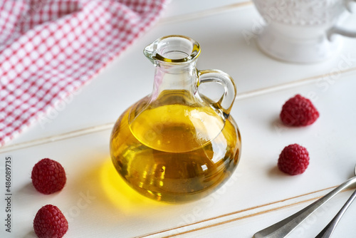 A bottle of flax seed oil with fresh berries photo