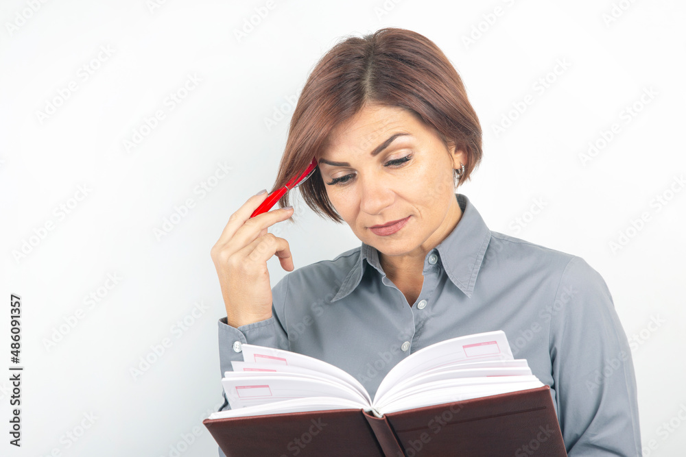 Business lady with a red pen and documents in her hands on a white background. Business lady with a red pen and documents in her hands on a white background.