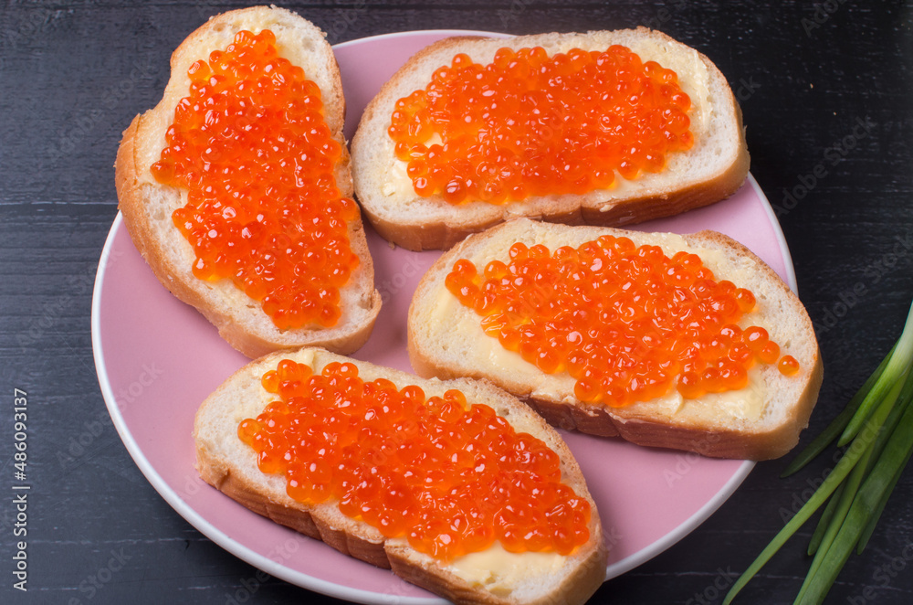 sandwiches with red caviar. Serving a delicacy on a plate sandwiches with red caviar. Serving a delicacy on a plate