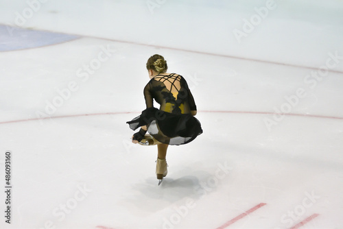 Girl figure skater rolls on a skating rink with artificial ice  photo