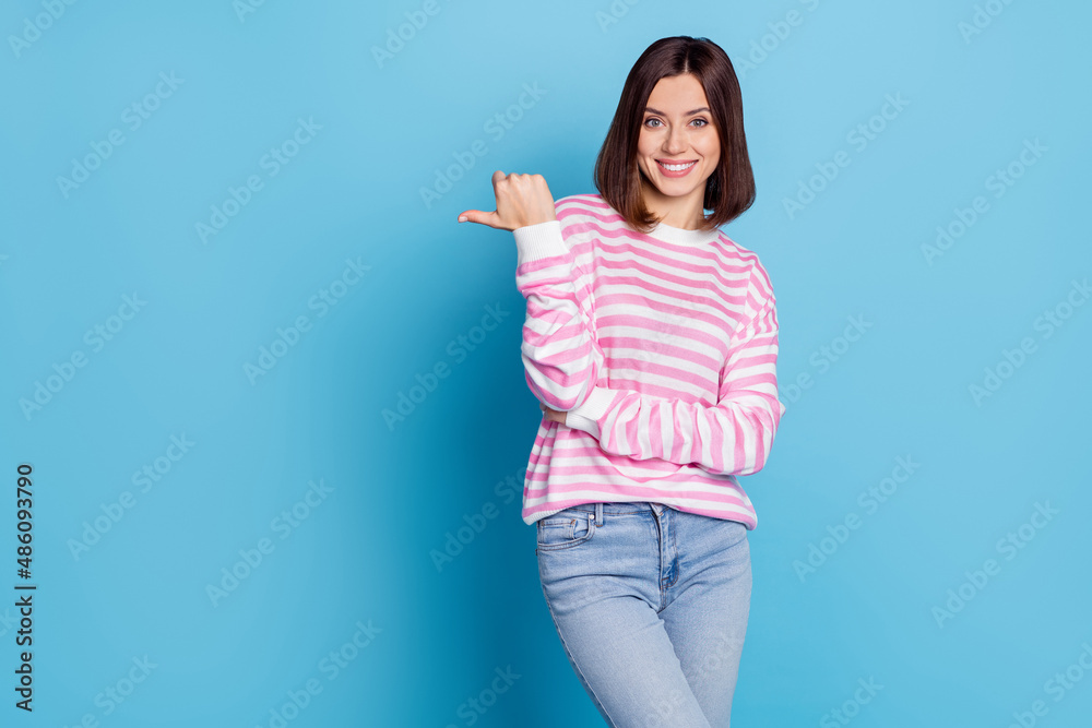 Photo of cute millennial brunette lady index promotion wear shirt jeans isolated on blue background Photo of cute millennial brunette lady index promotion wear shirt jeans isolated on blue background