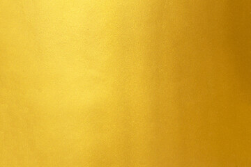 Gold wall texture background. Yellow shiny gold foil paint on wall sheet with gloss light reflection,