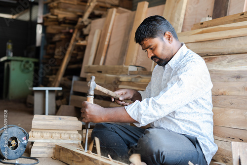 Billede på lærred Indian carpenter making wood design by using carpentry tools at workplace - concept of skilled occupation, creativity and local artisans