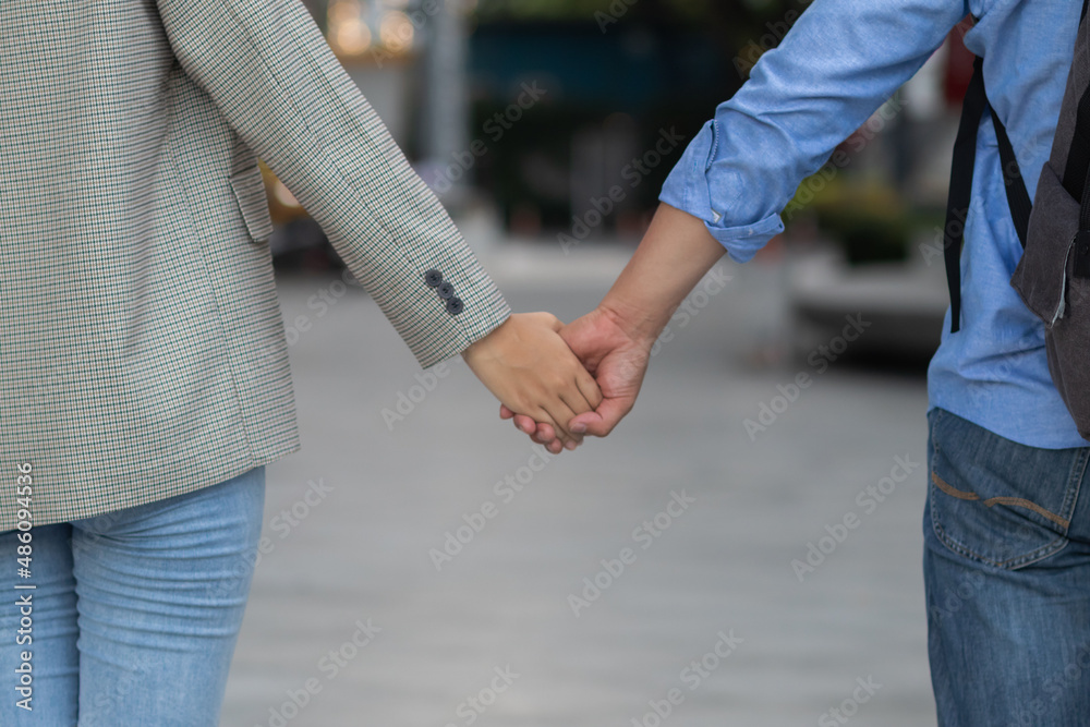 A couple happily walking hand in hand down the aisle and her lover wants to express their love and propose to their girlfriend on Valentine's Day. The concept of a happy couple walking hand in hand.