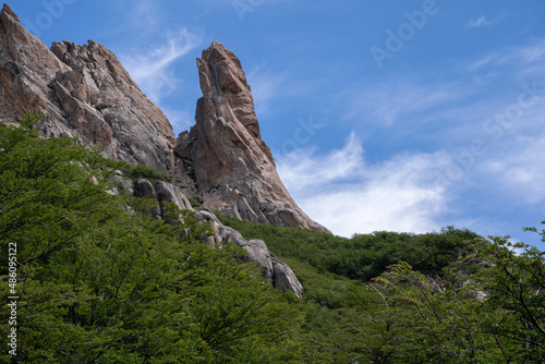 View of the forest and rocky formations under a deep blue sky. 