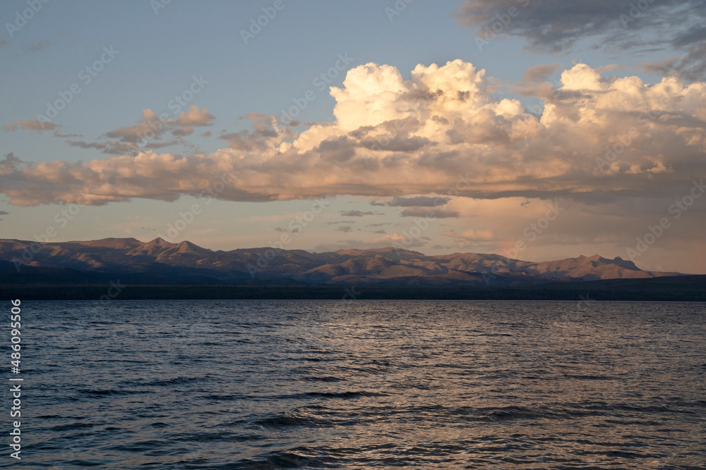Magical view of Nahuel Huapi lake at sunset. Beautiful clouds and dusk colors in the sky.
