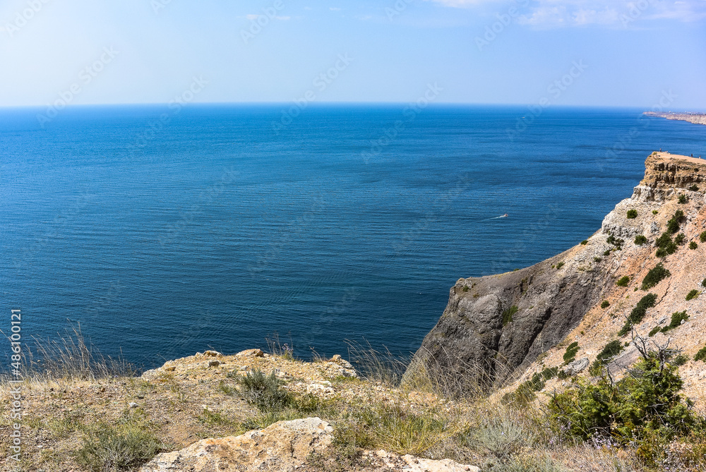 Cape Fiolent in Balaklava, Russia. View from the top of the cliff. azure sea, sunny day against a clear sky.