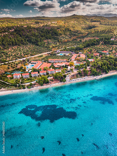 Aerial view of the idyllic seascape on the Sithonia peninsula in Halkidiki. High above the roofs of the resort village with villas and hotels. Visit top beaches of Greece
