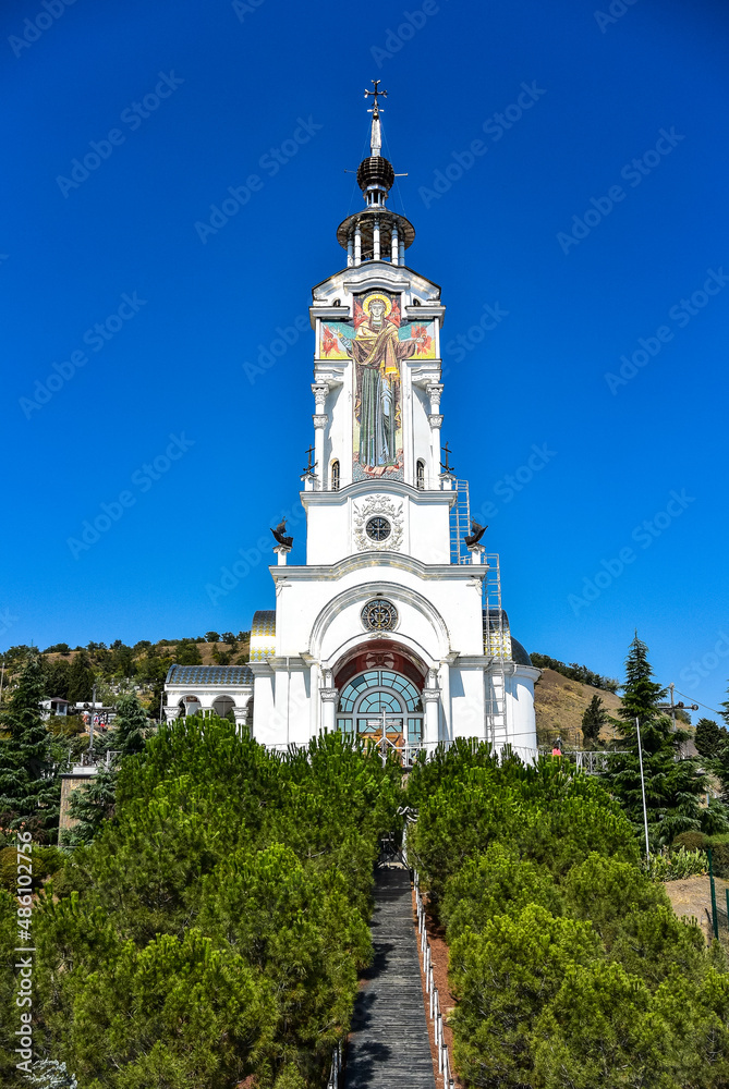 Orthodox Church of St. Nicholas the Wonderworker against the blue sky on the southern coast of Crimea. Russia.