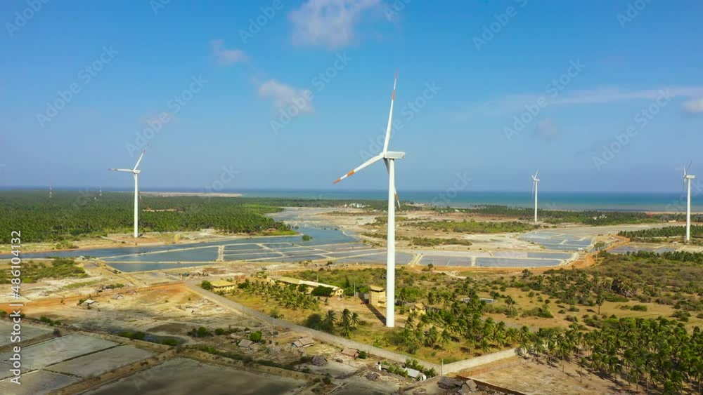 Wind turbines producing clean sustainable energy, clean energy future. Wind power plant. Kalpitiya, Sri Lanka. Wind turbines producing clean sustainable energy, clean energy future. Wind power plant. Kalpitiya, Sri Lanka.