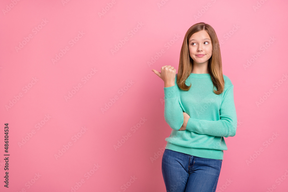 Photo of dreamy sweet school girl dressed teal pullover pointing empty space isolated pink color background Photo of dreamy sweet school girl dressed teal pullover pointing empty space isolated pink color background