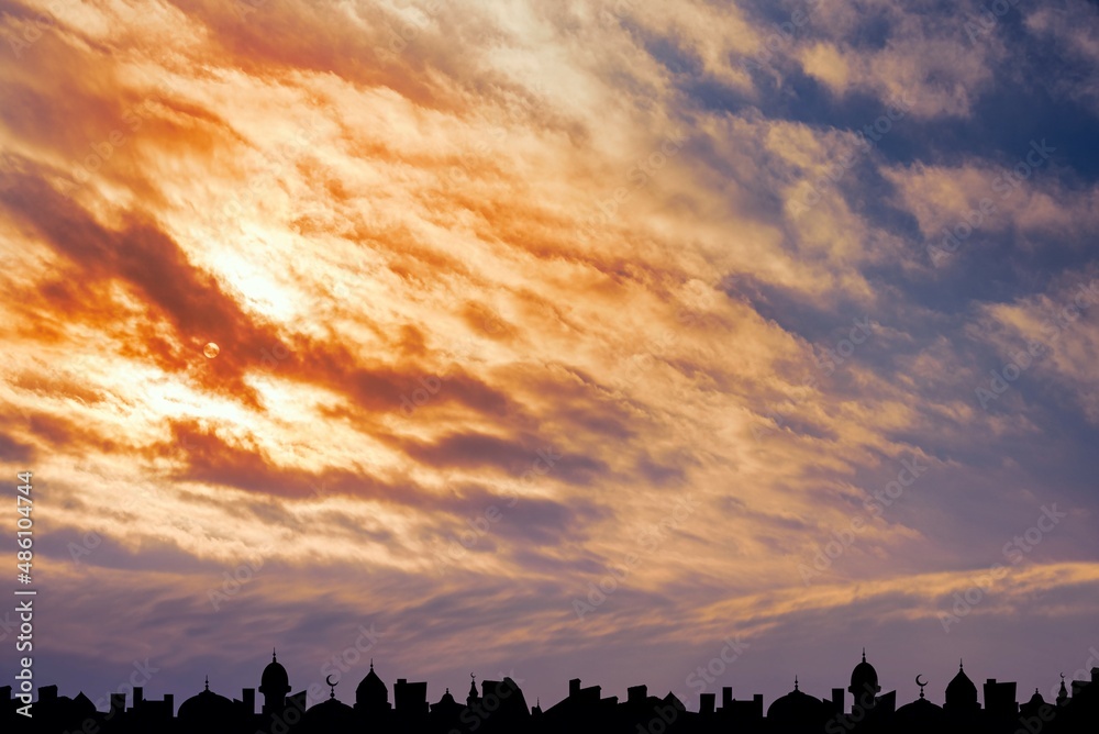silhouette of a beautiful mosque against the background of sunset sun