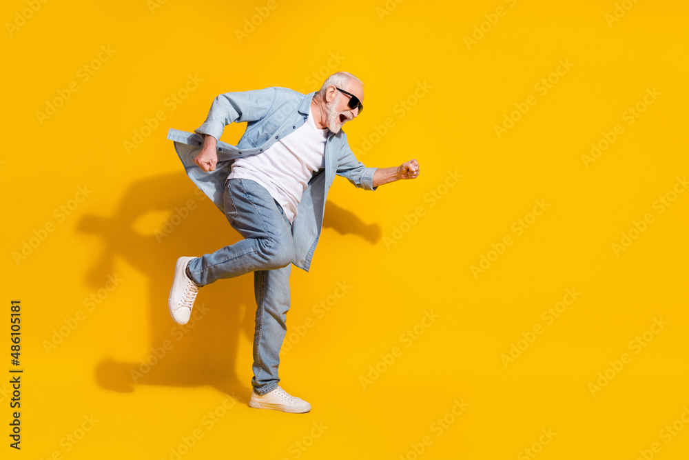Full length body size view of attractive cheerful crazy grey-haired man having fun great success isolated on bright yellow color background Full length body size view of attractive cheerful crazy grey-haired man having fun great success isolated on bright yellow color background