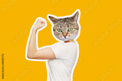 Strong woman headed by cat head raises arm and shows bicep isolated on a color yellow background. Support animal rights, activism. Trendy collage in magazine style. Contemporary art. Modern design photo