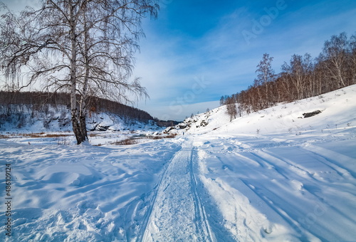 Winter landscape with trees and sky from the high rocky river bank © Александр Коликов