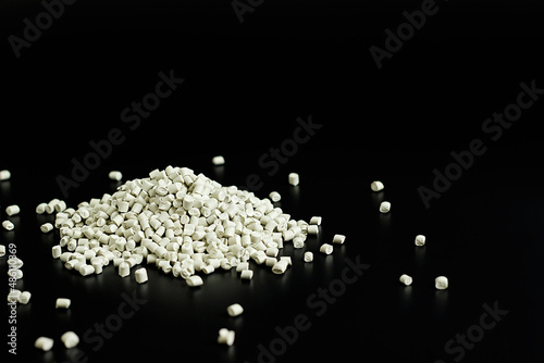 white granules of polypropylene, polyamide in a test tube. Background. Plastic and polymer industry. Microplastic products.