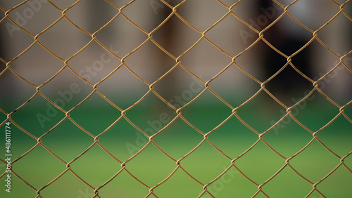 Close up of old chain fence at a football ground.