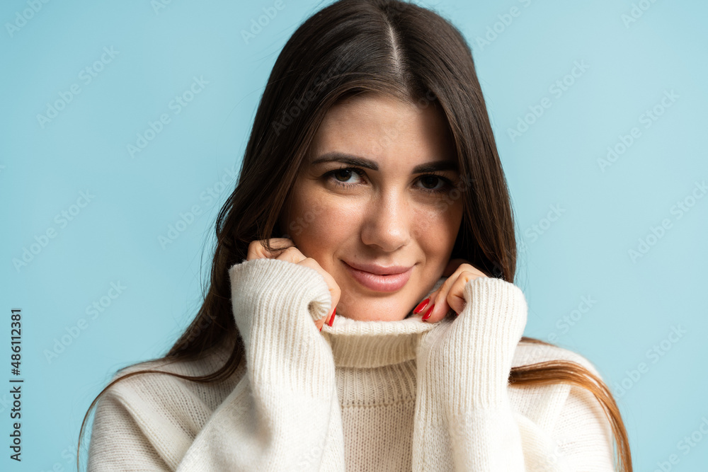 Positive beautiful young woman smiling positively while looks at camera with carefree face expression Positive beautiful young woman smiling positively while looks at camera with carefree face expression