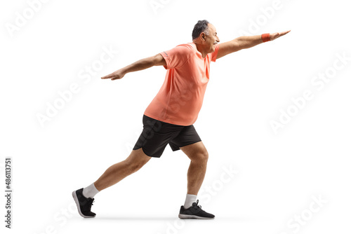 Full length shot of a mature man in sportswear exercising and stretching