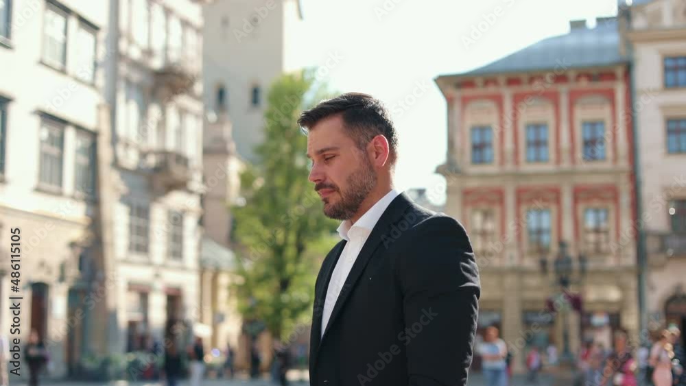 Sideview cinematic portrait of young handsome caucasian man walking seriously. Man looking away. Beautiful blue eyes. Joyfull concept. Sunlight in the background. Sideview cinematic portrait of young handsome caucasian man walking seriously. Man looking away. Beautiful blue eyes. Joyfull concept. Sunlight in the background.