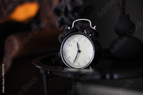 black alarm clock on a black background