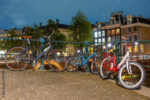 Cycling Family :) on the Canal Embankment in Amsterdam at Night