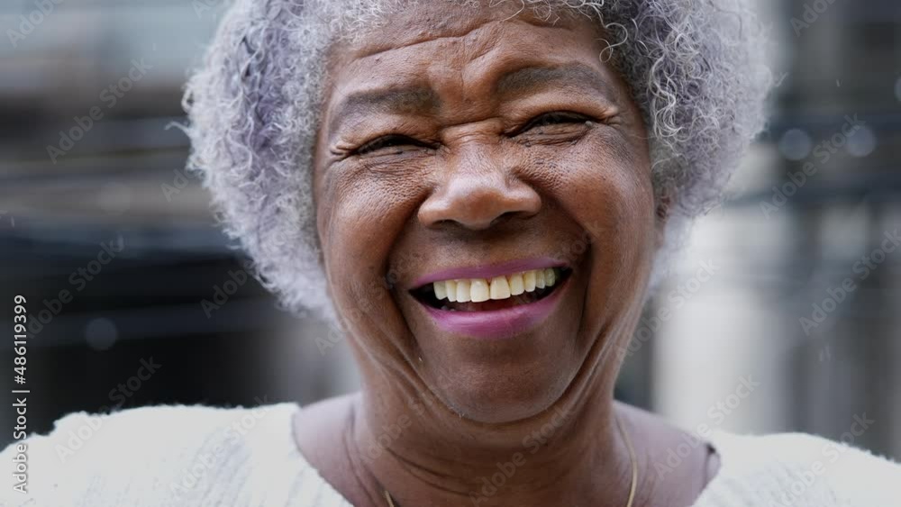A joyful older black woman authentic smile real happy expression