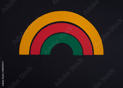 Black history month colors rainbow. Paper cut abstract composition on dark background.