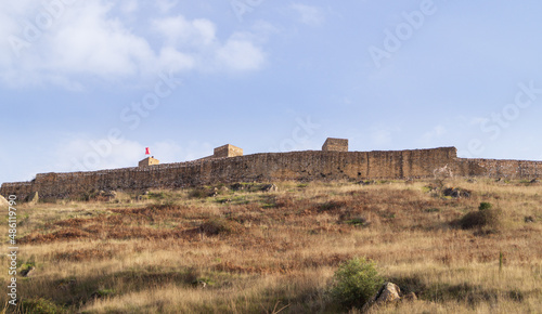 Views of the wall of Aracena Castle on a beautiful sunny day. Castle built in the mid 13th century in the Andalusian village of Aracena (Andalusia, Spain). photo