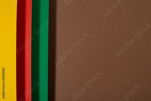 Black history month colors background. Red, green and yellow paper cut abstract composition.