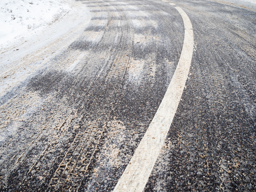 Fototapeta premium bend of iced slippery city road in winter