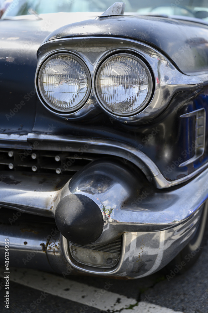 The headlights of an American veteran car.